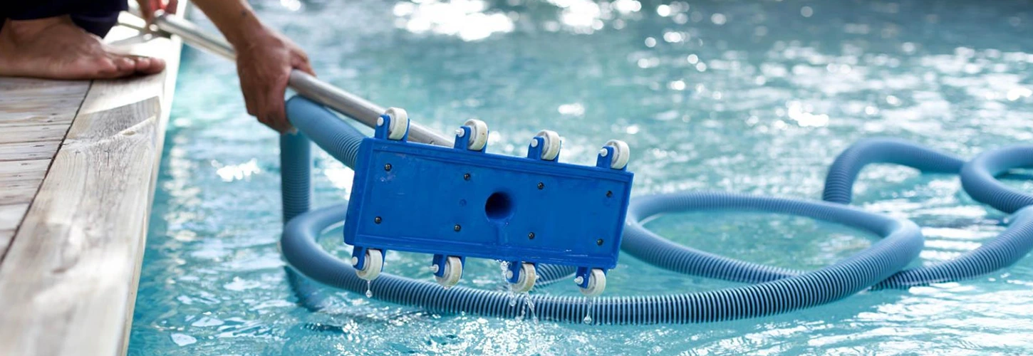 Expert pool cleaner testing water chemistry in a backyard pool under West Texas sun